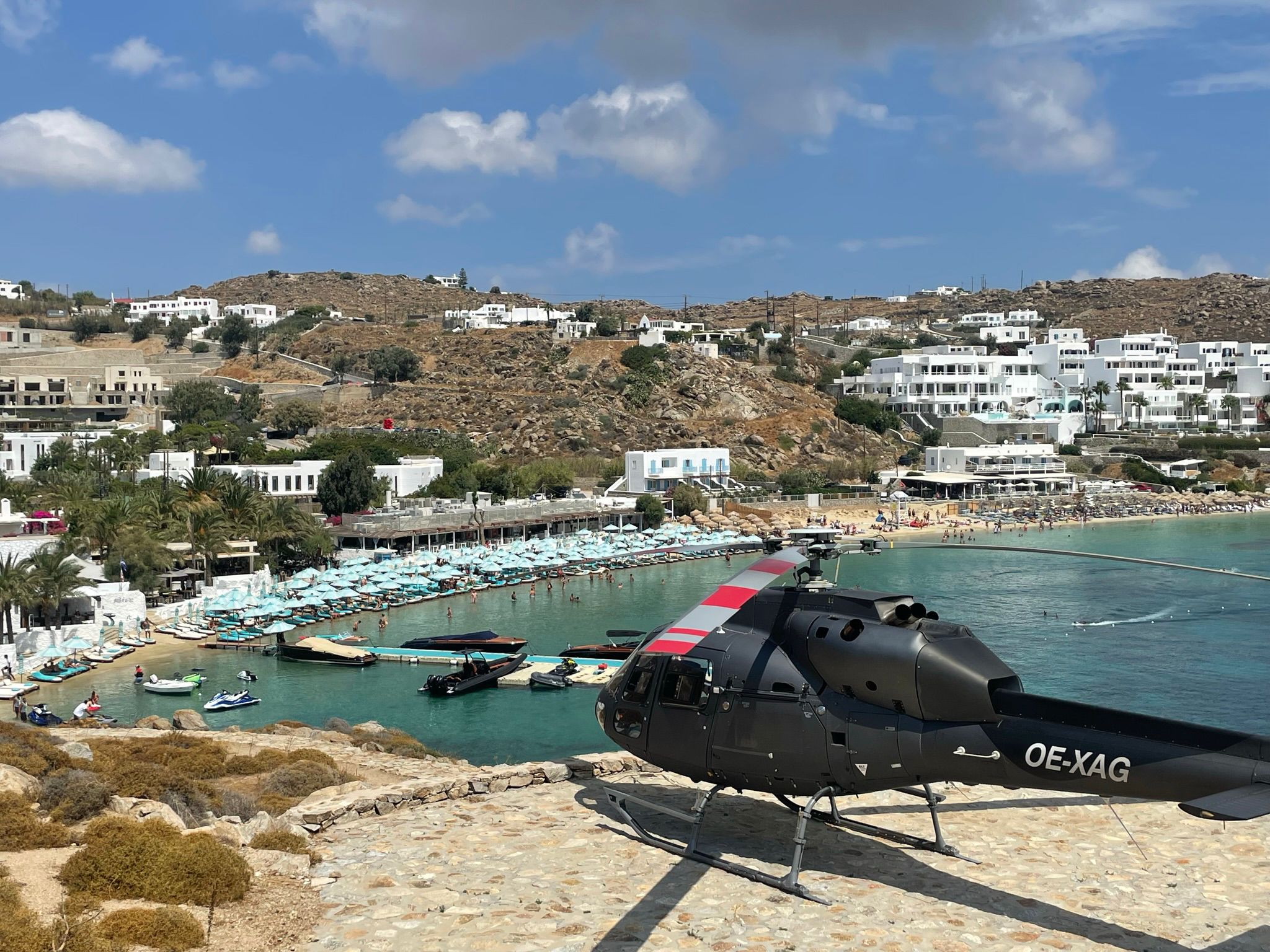 A landed helicopter, and a view of a beach